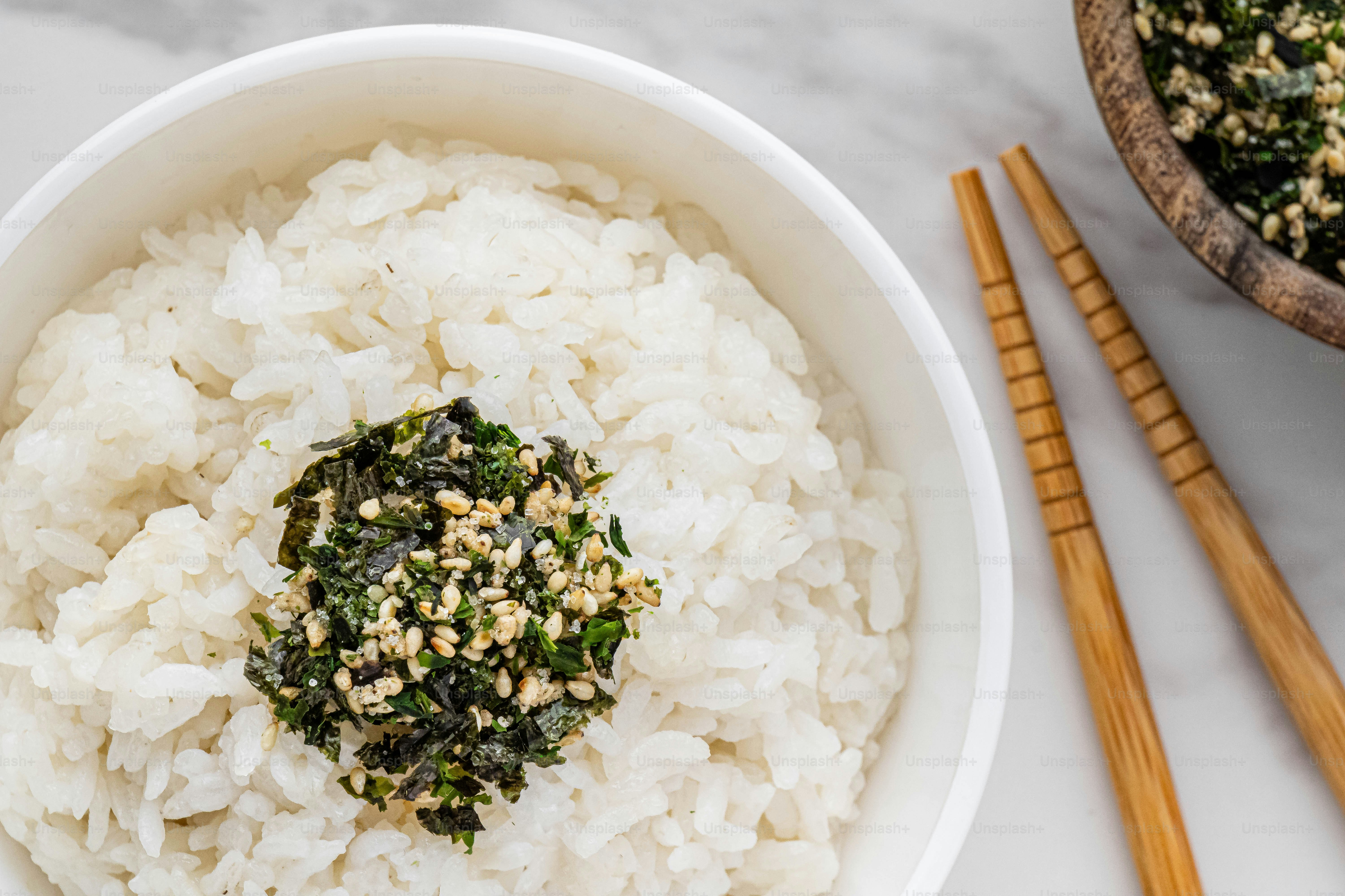 a bowl of rice and chopsticks on a table