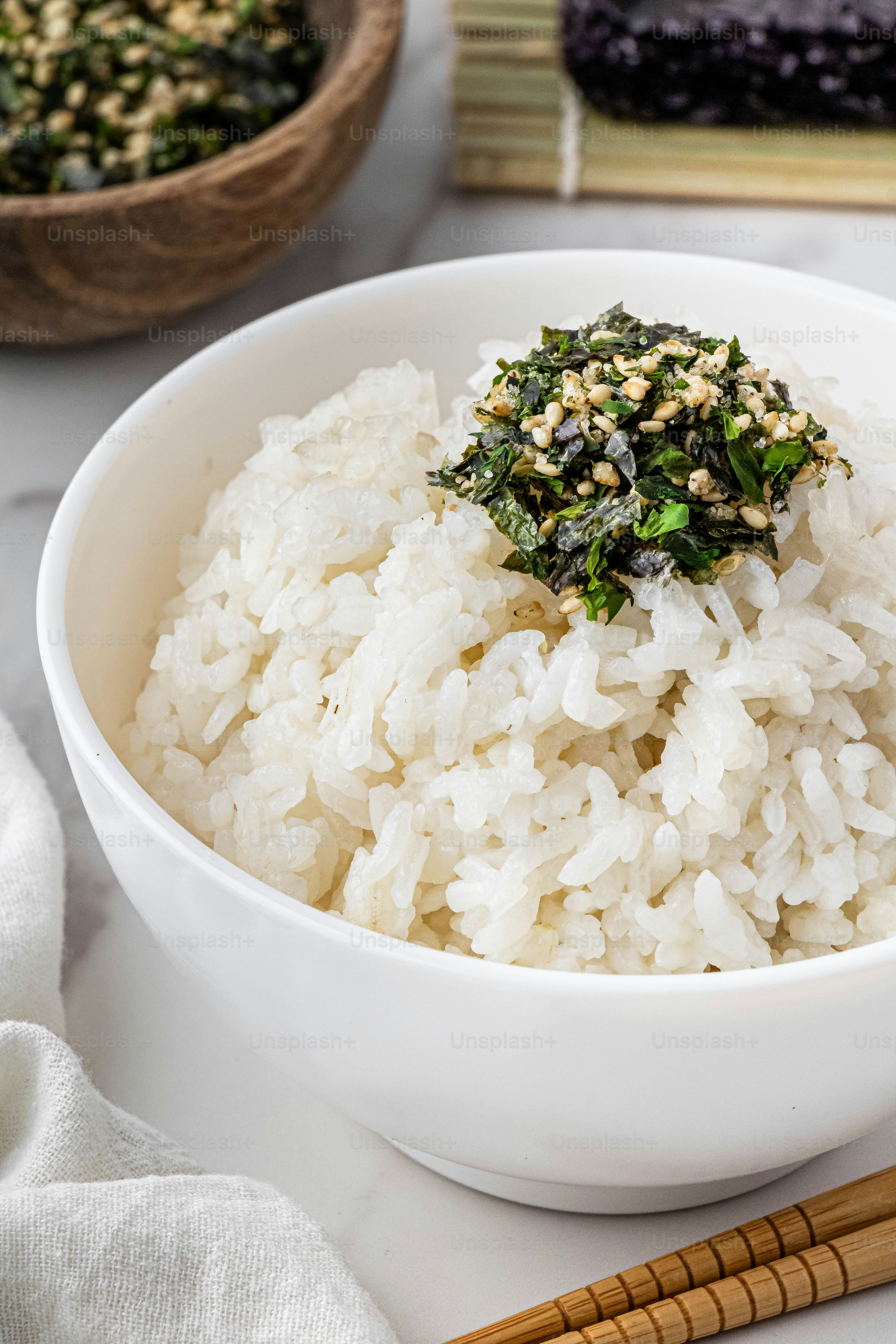 a white bowl filled with rice and greens