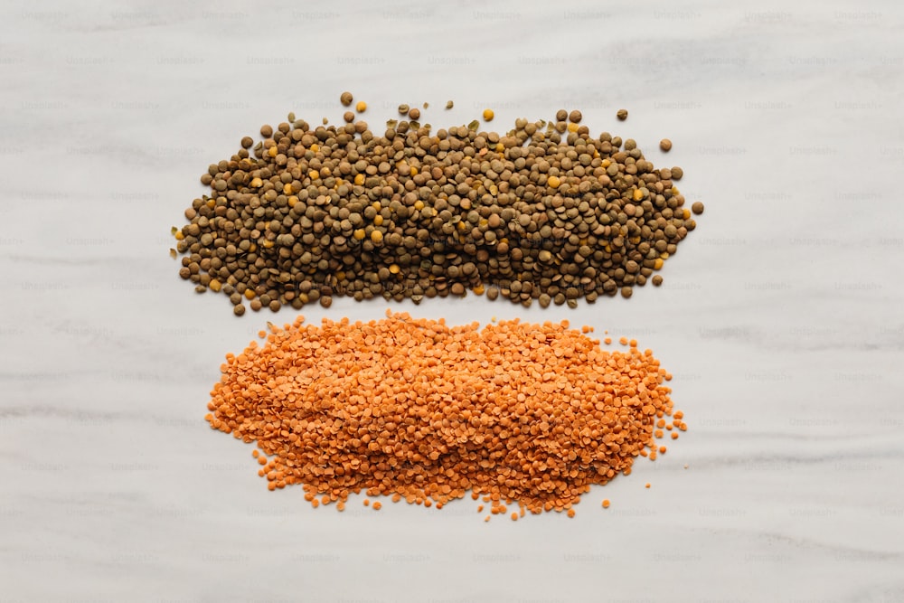 three different types of spices on a white surface