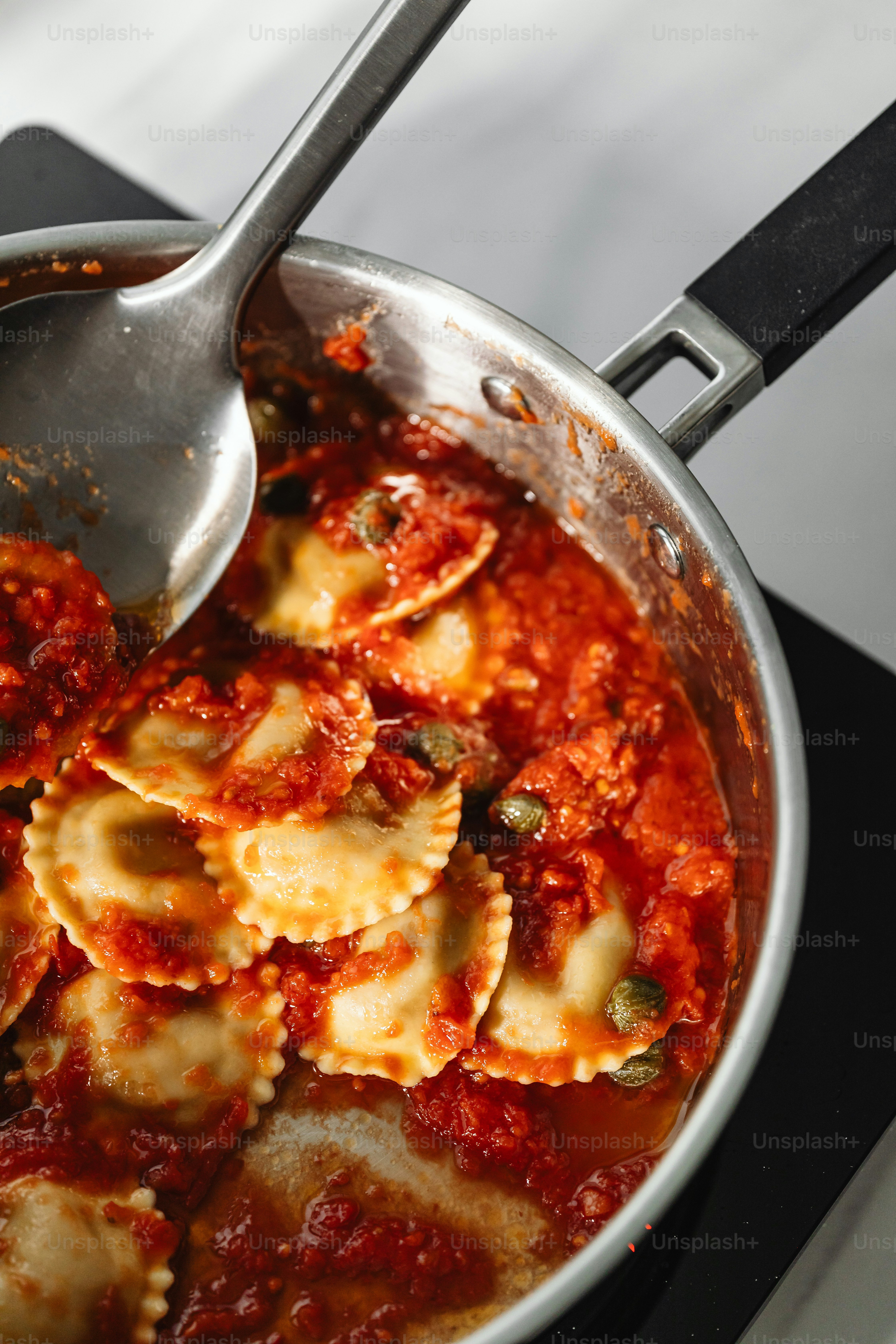 a pan filled with pasta and sauce on top of a stove
