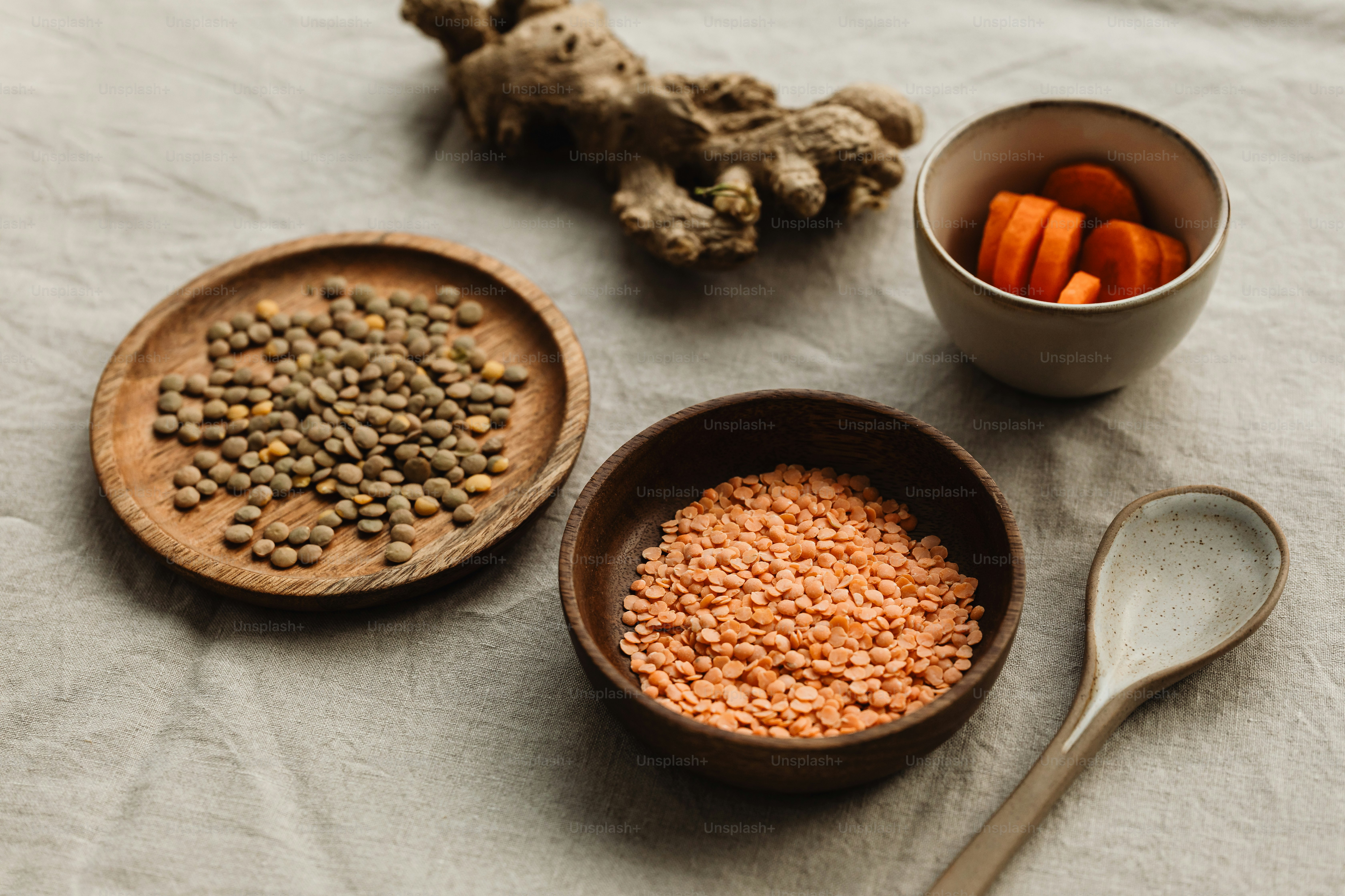 a table topped with bowls of food and a spoon