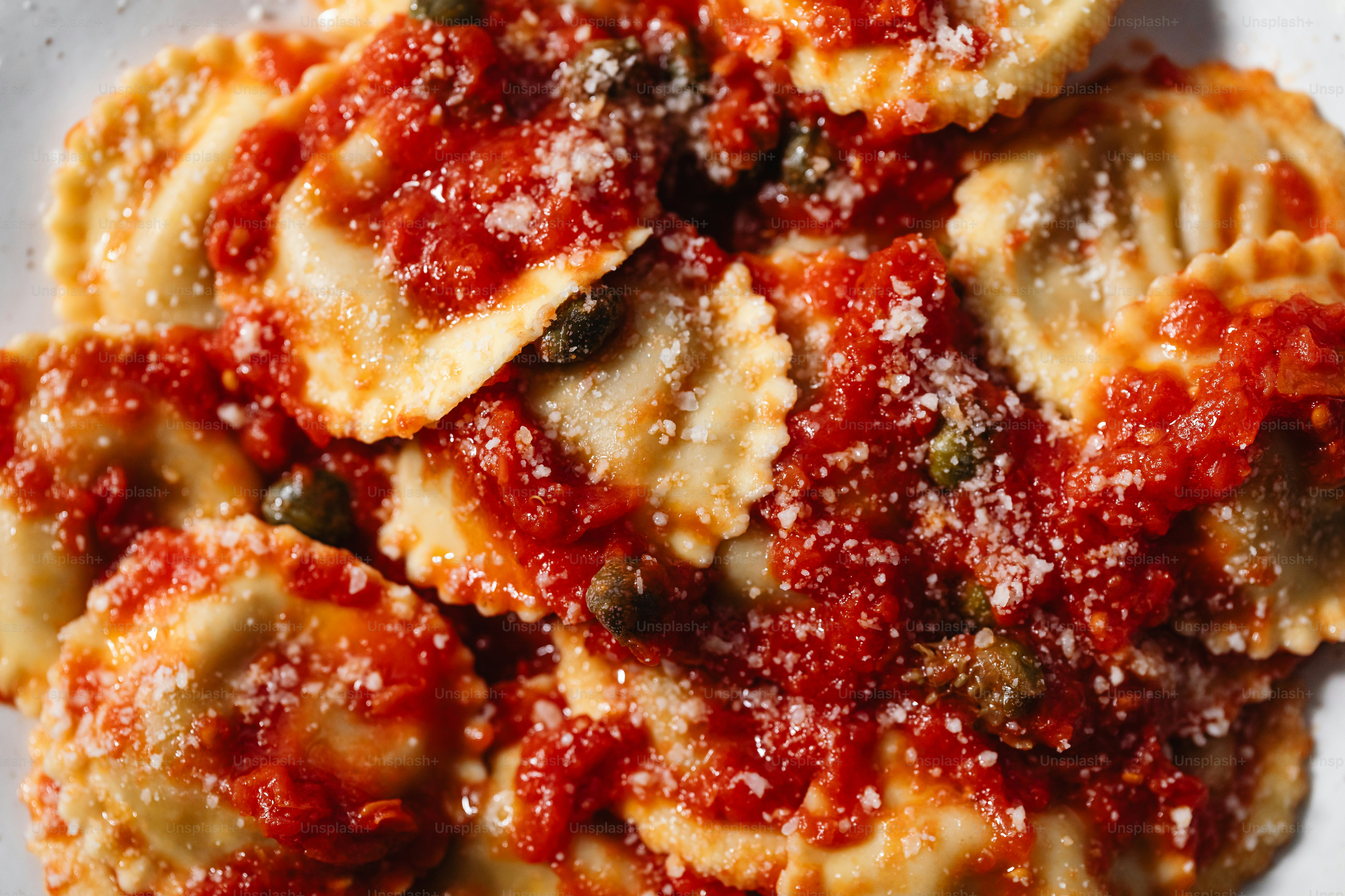 a white plate topped with ravioli covered in sauce
