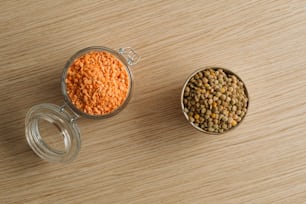 two glass containers filled with food on top of a wooden table