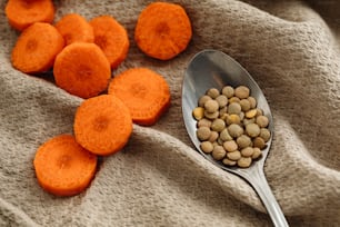 a spoon full of food sitting on top of a blanket