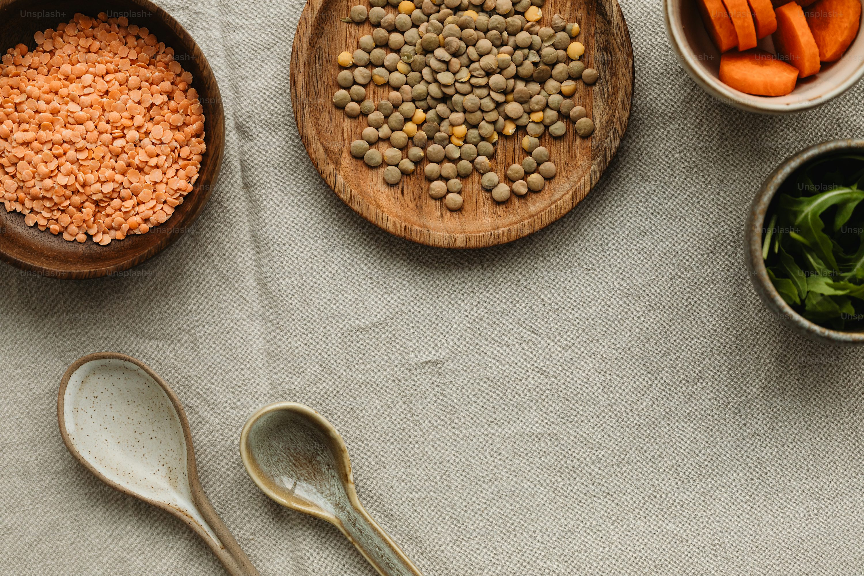 lentils a table topped with bowls of lentils and spoons