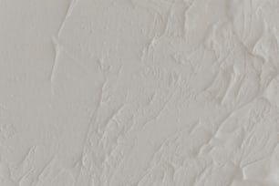 a close up of a wall with white paint