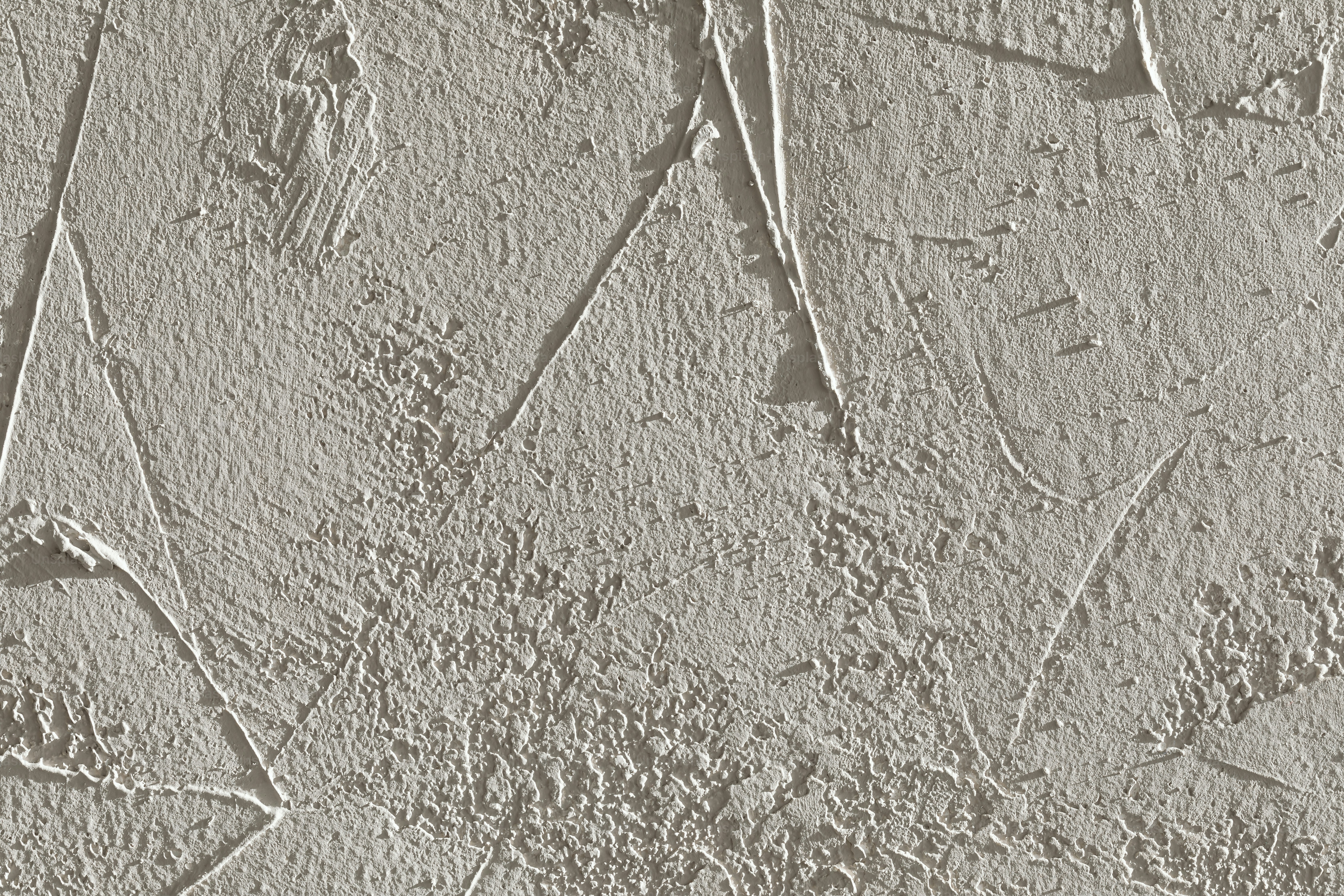 a close up of a cement wall with cracks in it