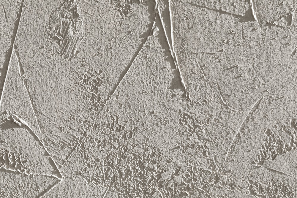 a close up of a cement wall with cracks in it