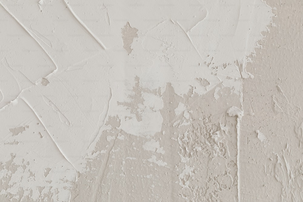 a white wall with peeling paint on it