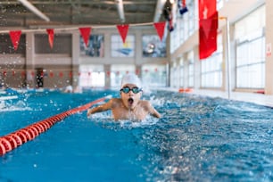 a man swimming in a pool wearing goggles
