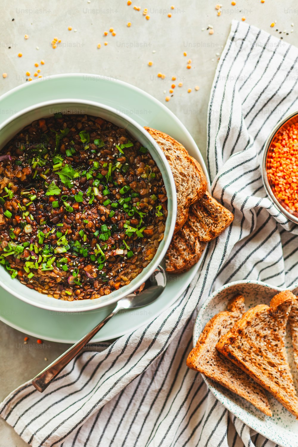 a bowl of beans and bread on a table