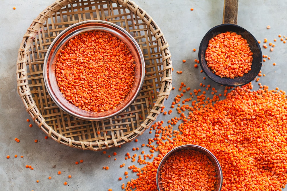 two bowls of red lentils on a table