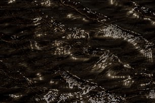 a black and white photo of water and light