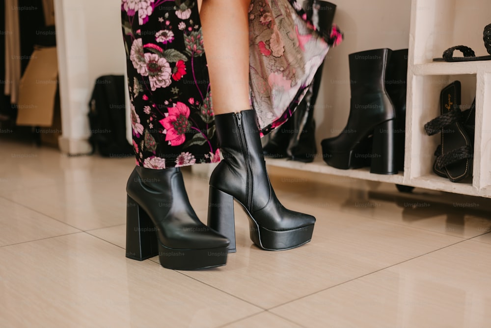 a close up of a person wearing high heel boots