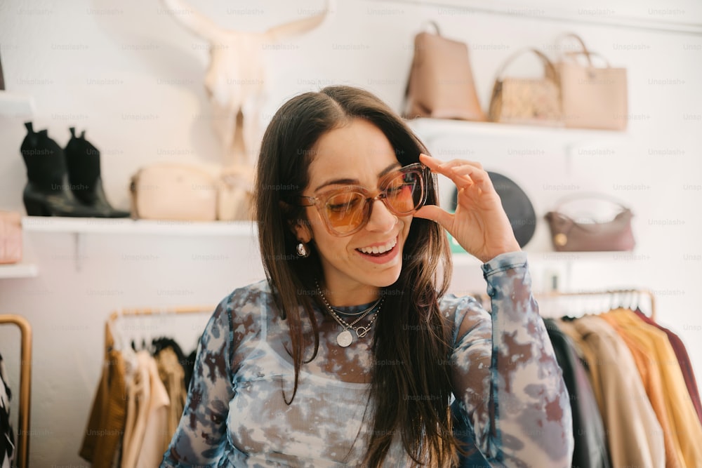 a woman in a store looking at a pair of sunglasses