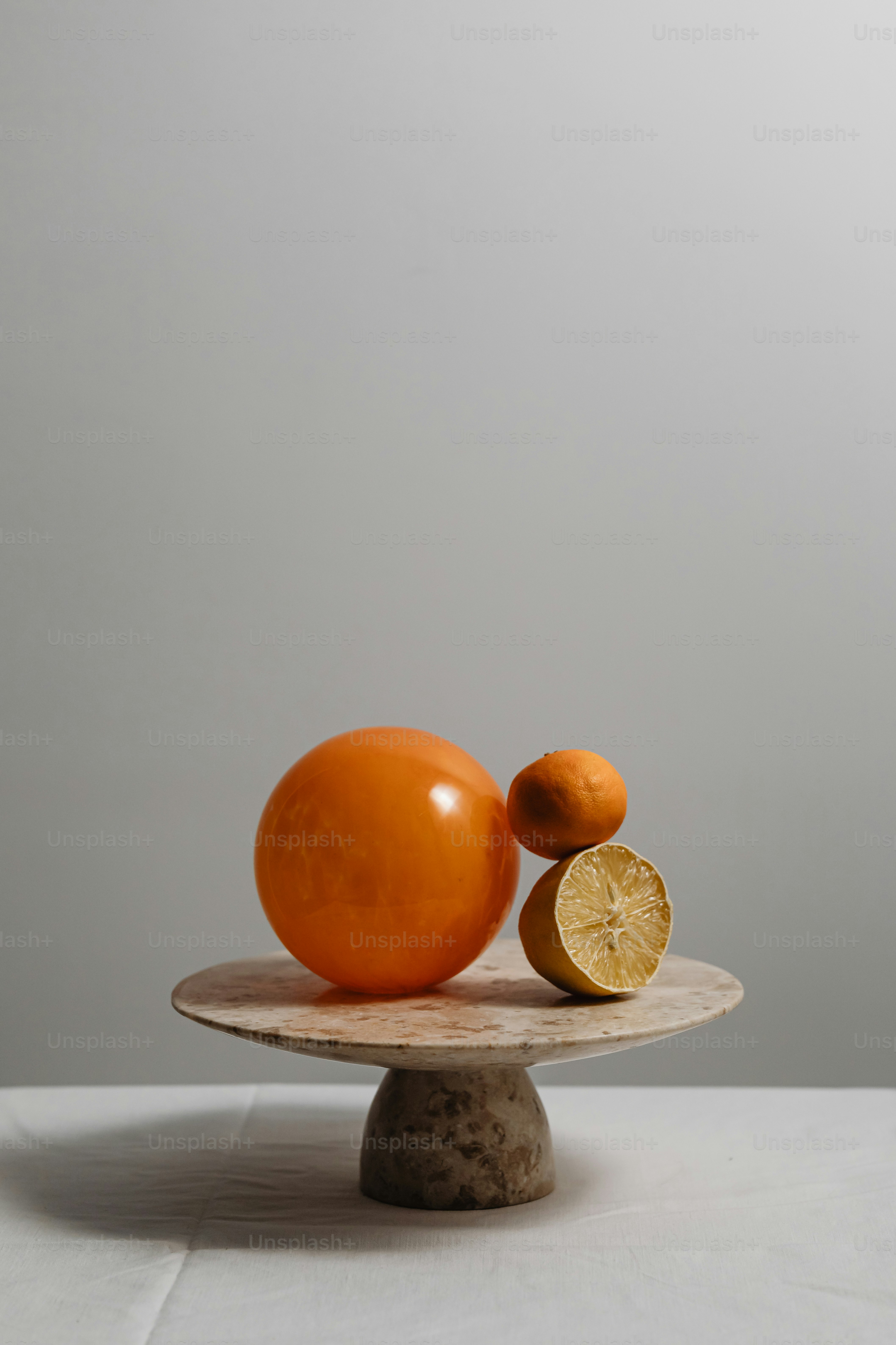 an orange sitting on top of a wooden plate