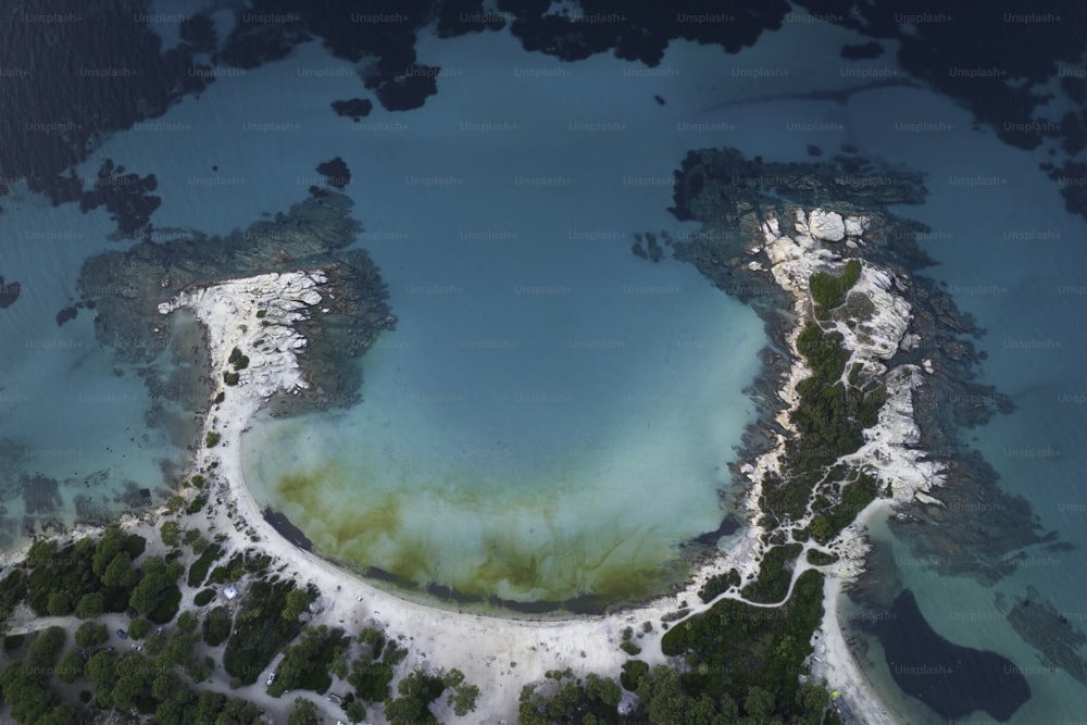 an aerial view of a body of water surrounded by trees