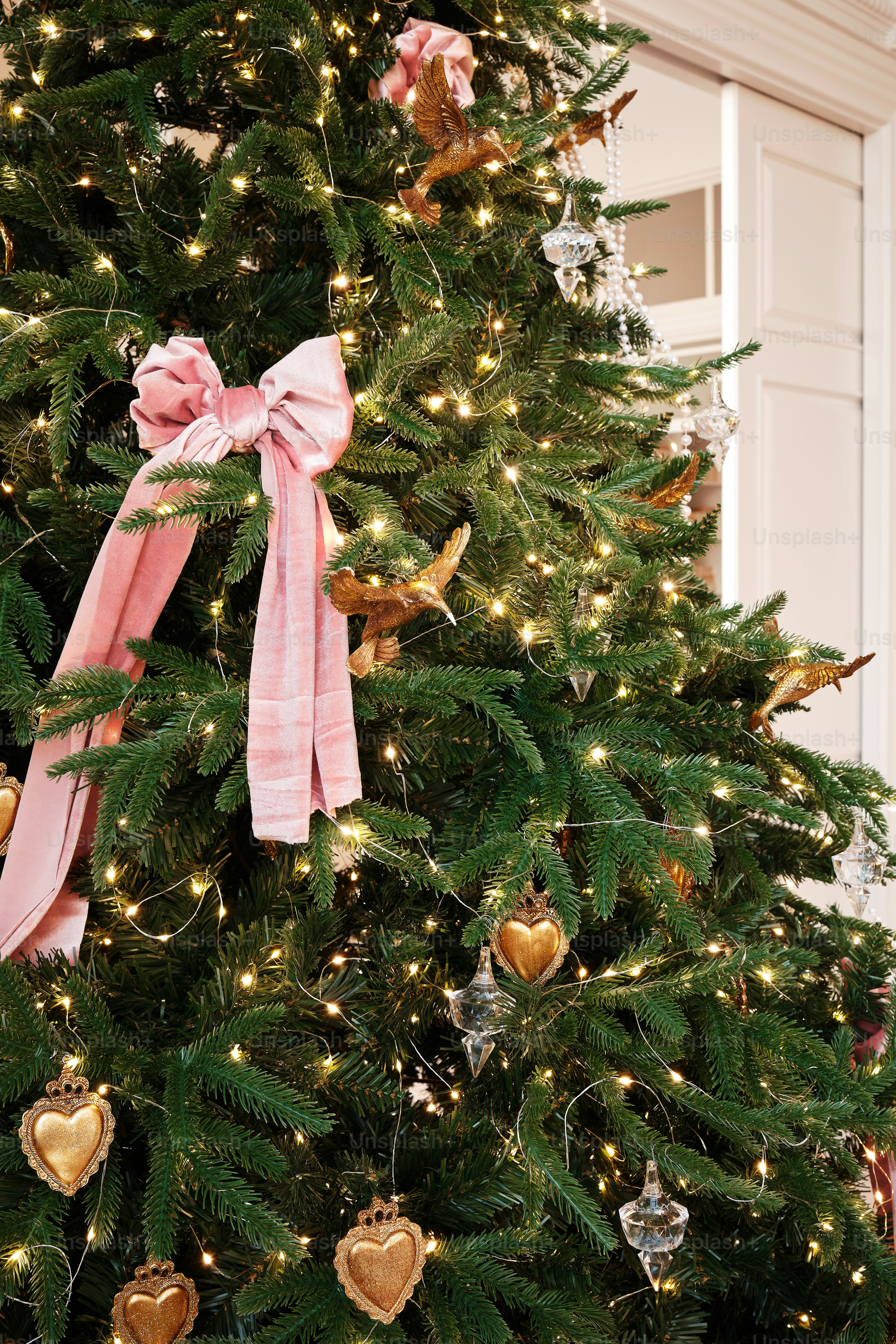 A decorated christmas tree with a pink bow photo Christmas tree Image
