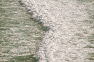 a person riding a surfboard on top of a wave