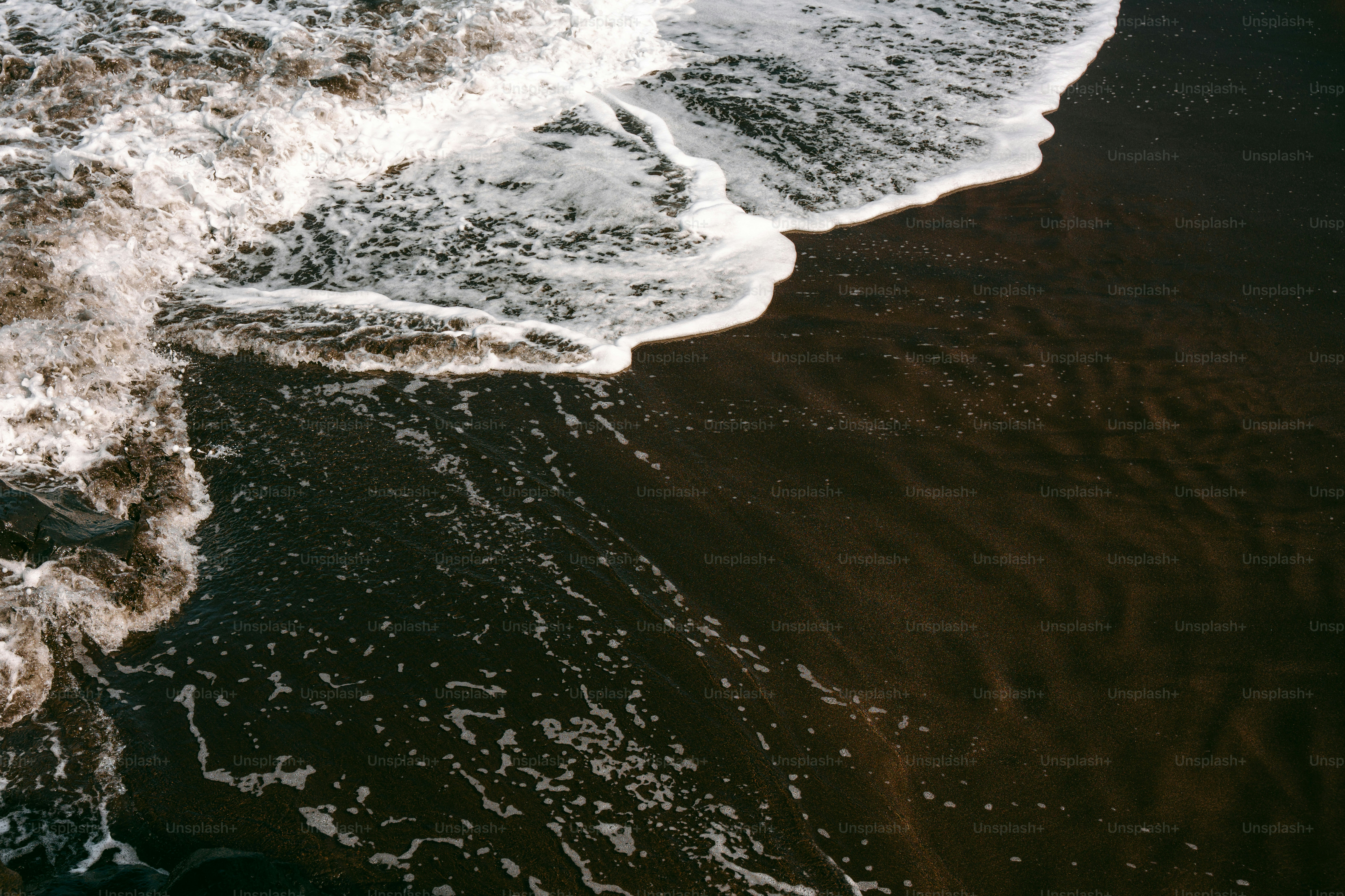 a person standing on a beach next to the ocean