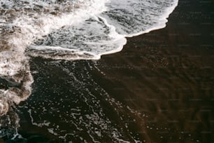 a person standing on a beach next to the ocean