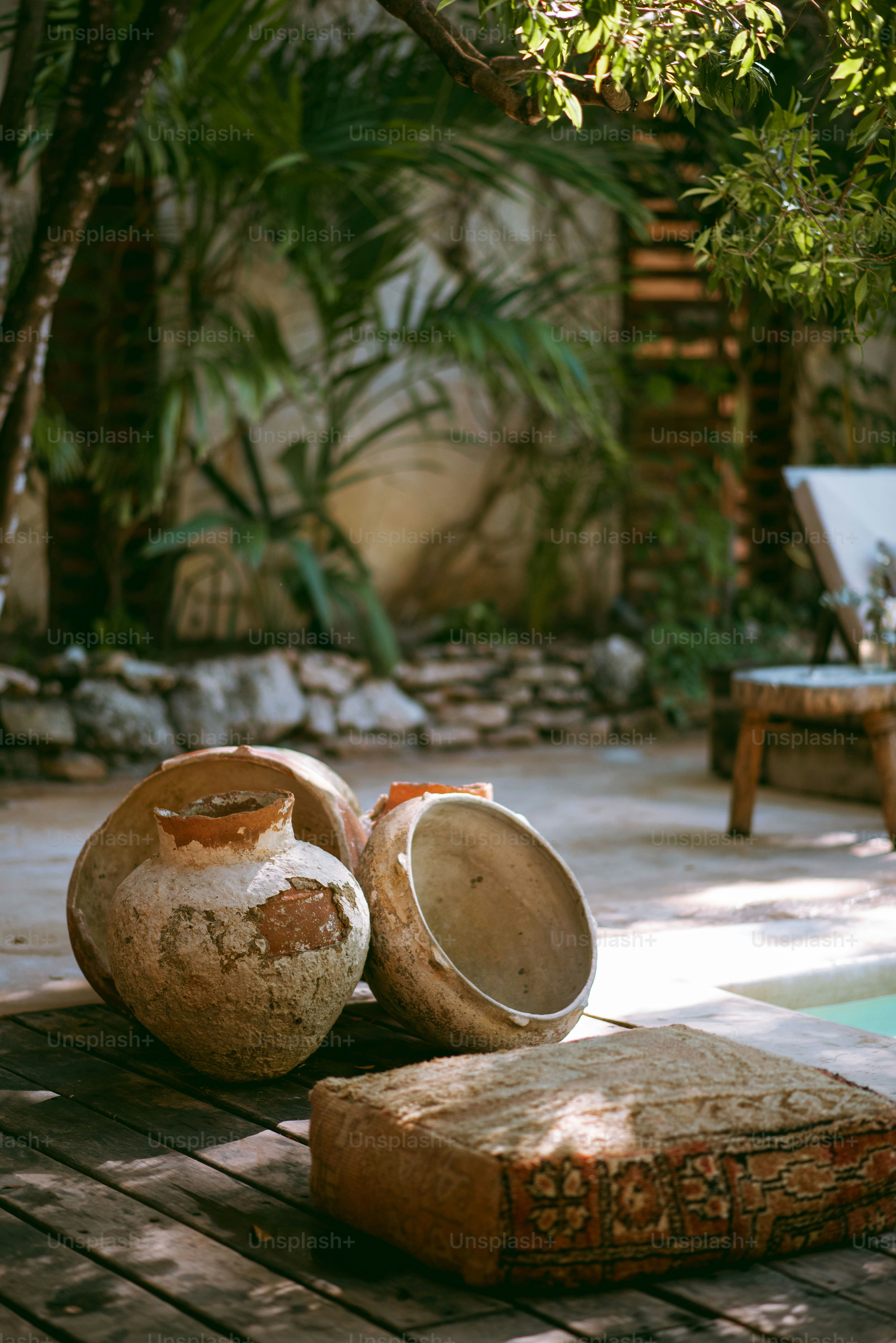 a couple of vases sitting on top of a wooden table