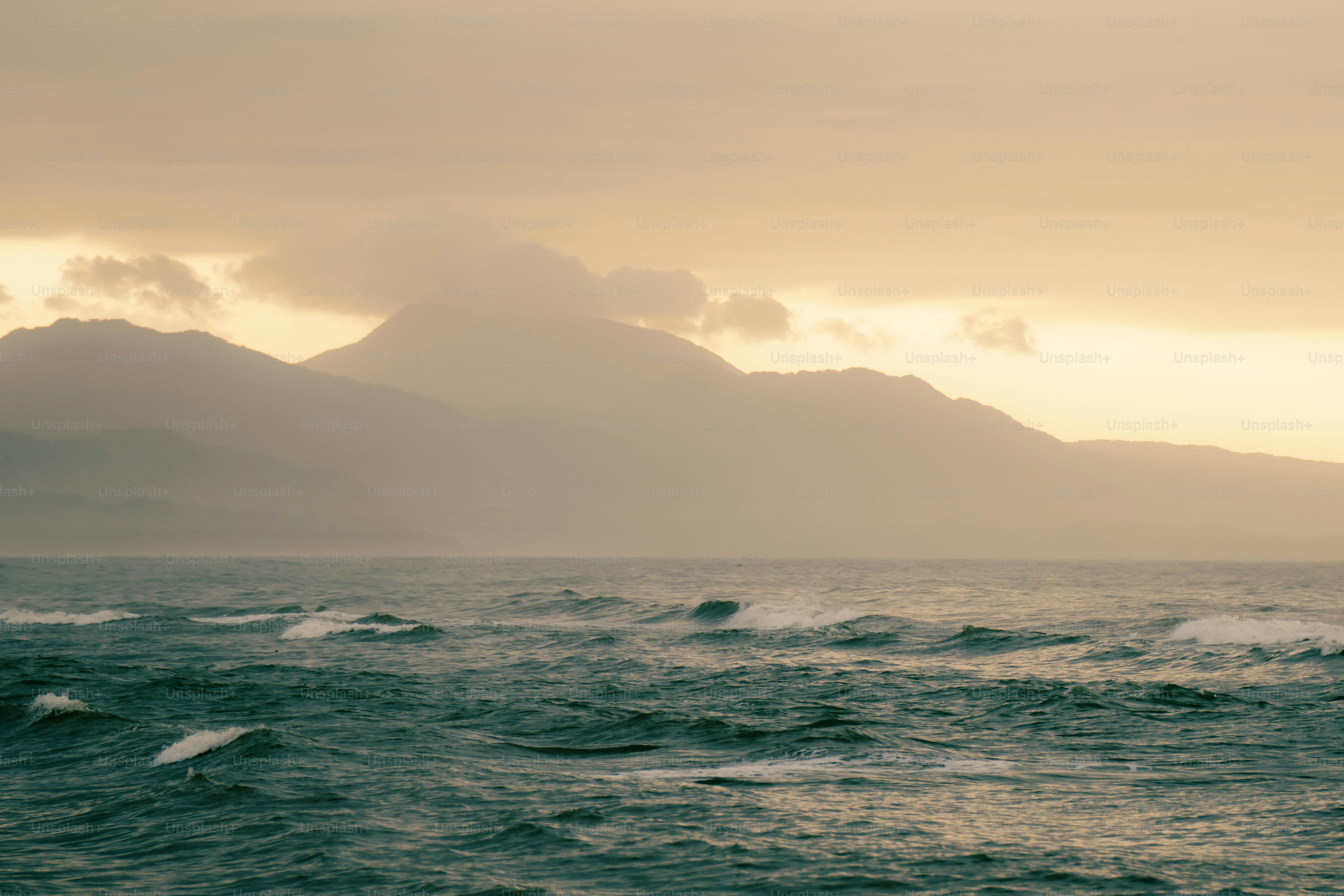 a large body of water with mountains in the background