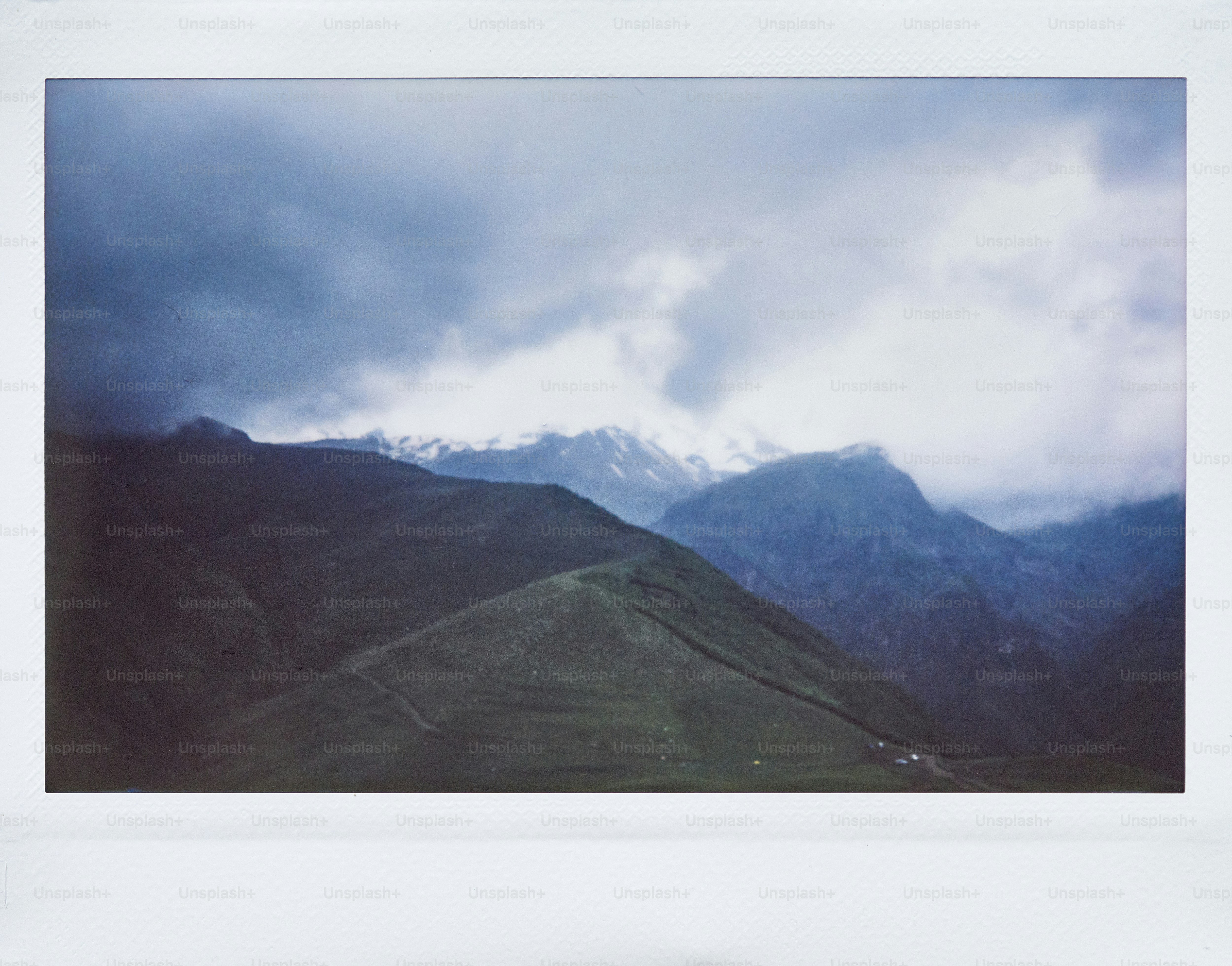a view of a mountain range with a cloudy sky