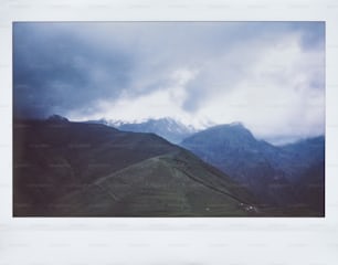 a view of a mountain range with a cloudy sky