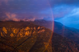 a double rainbow is seen over a mountain range