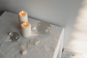 a couple of candles sitting on top of a table