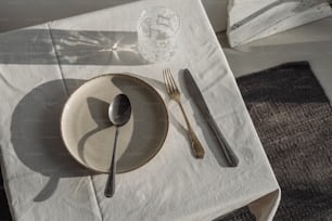 a table with a white table cloth and silverware