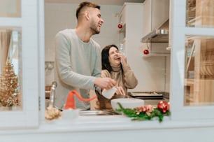 a man and a woman preparing food in a kitchen