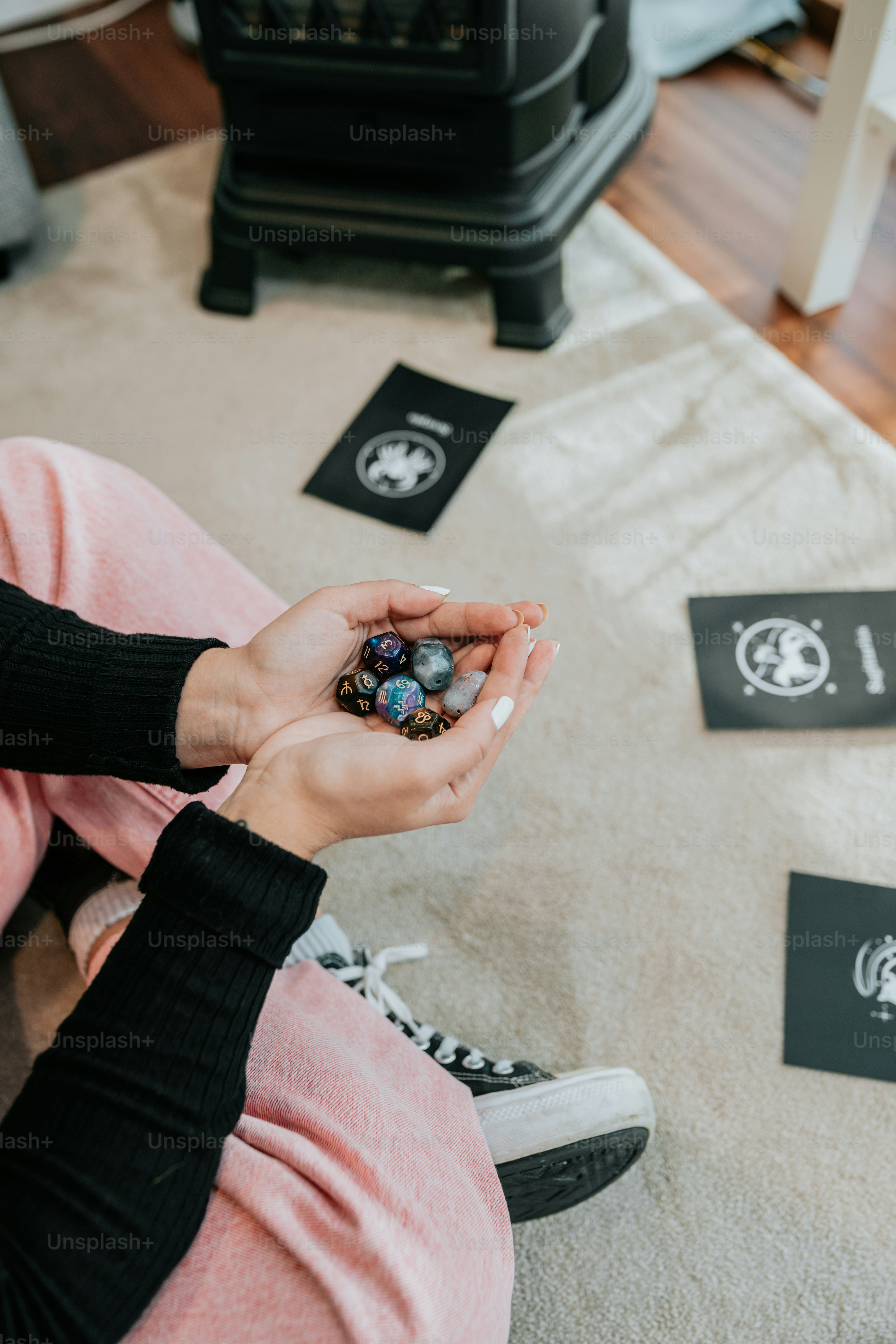 a woman sitting on the floor holding a cell phone