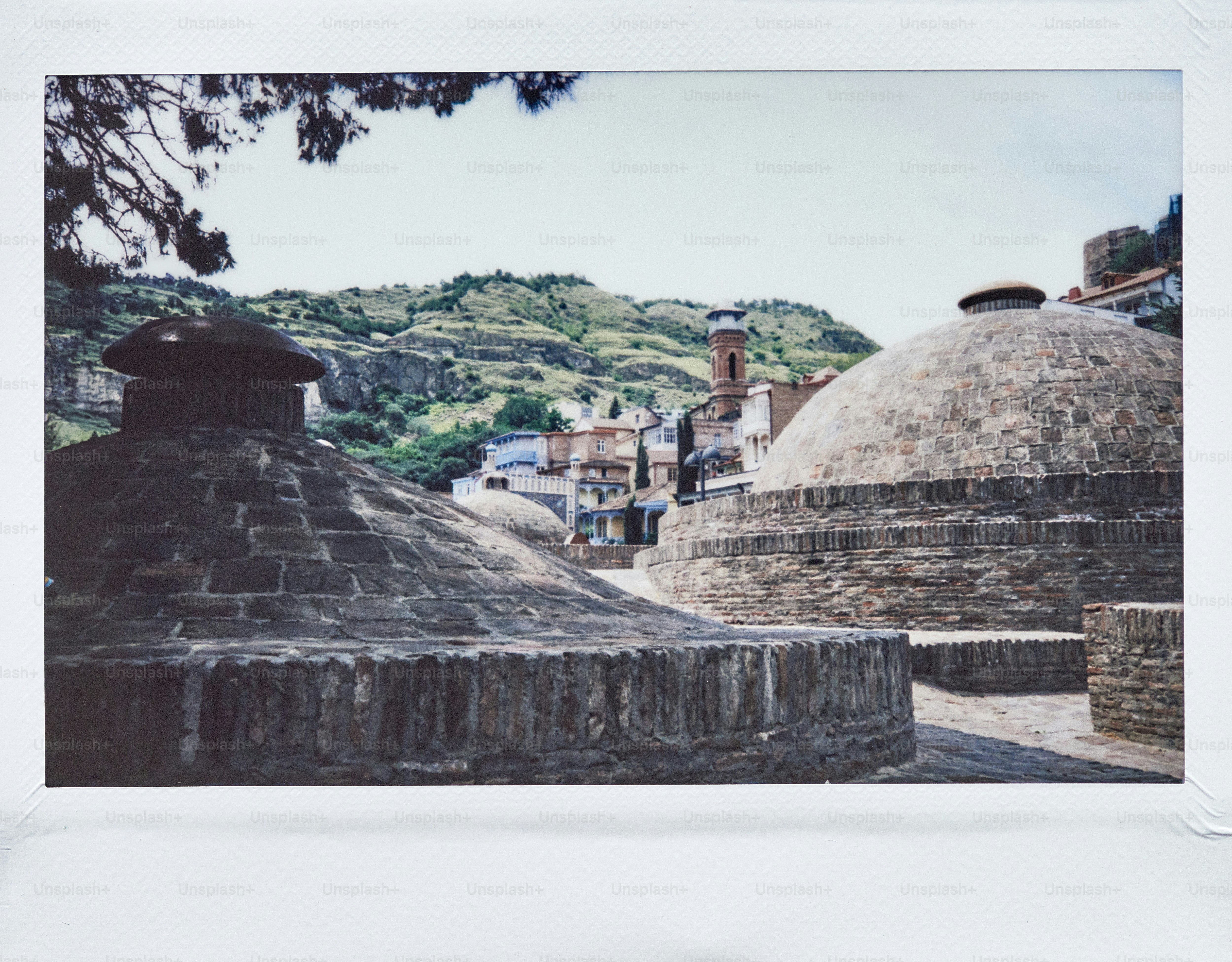 a picture of a stone building with a clock tower in the background