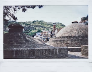 a picture of a stone building with a clock tower in the background