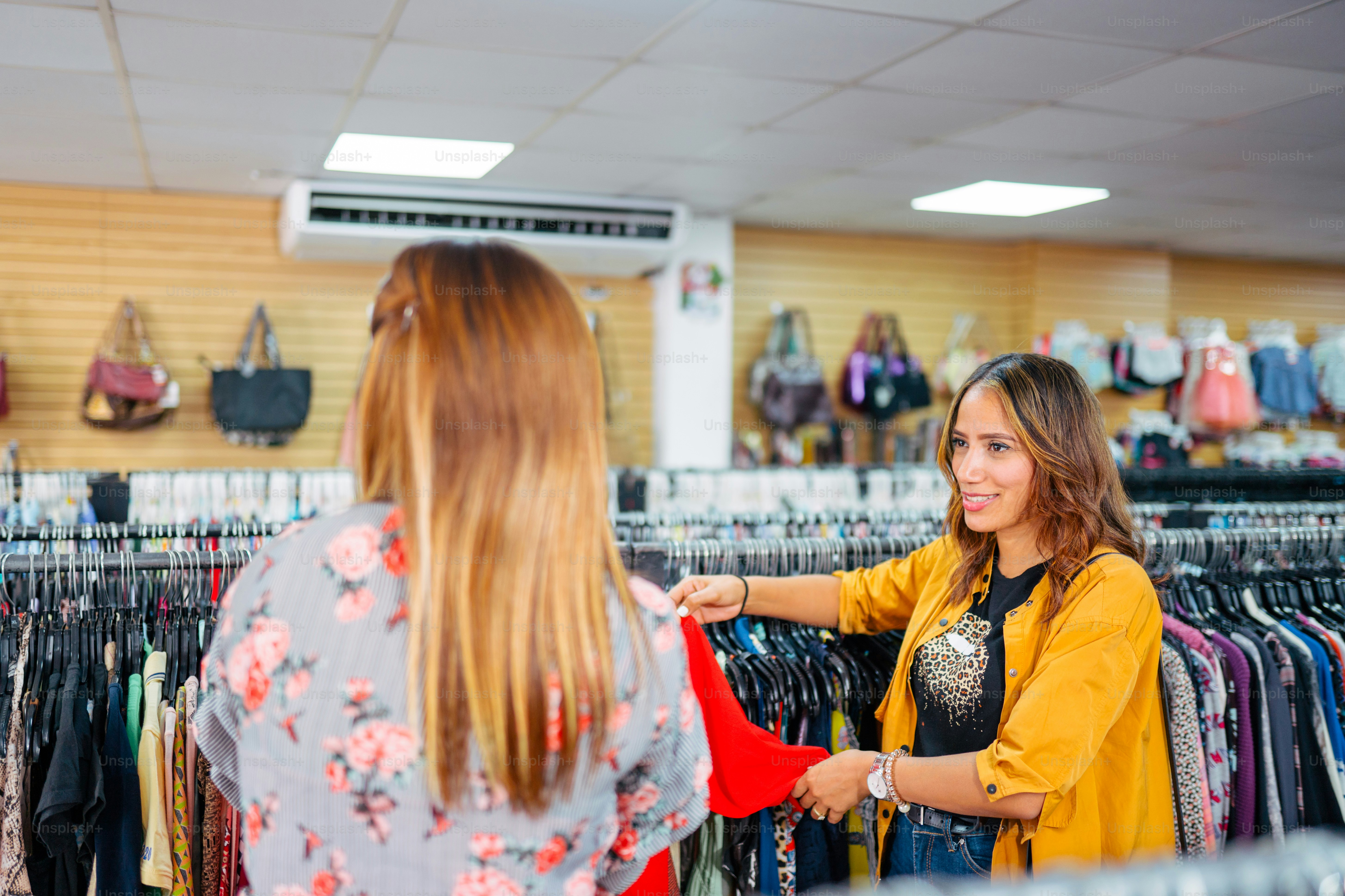 a woman is shopping in a clothing store