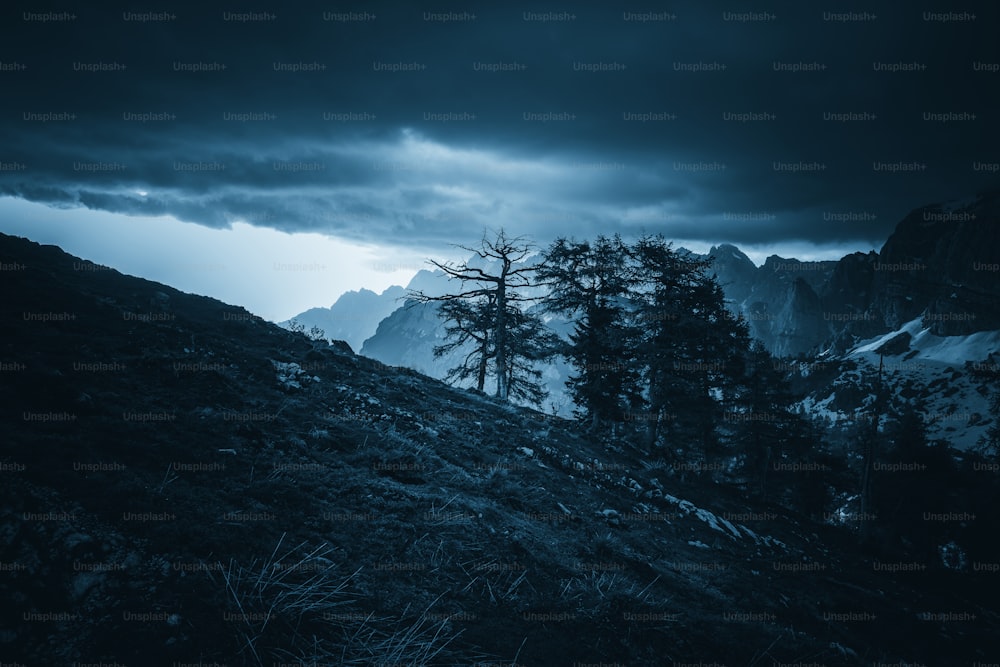 a black and white photo of a dark mountain