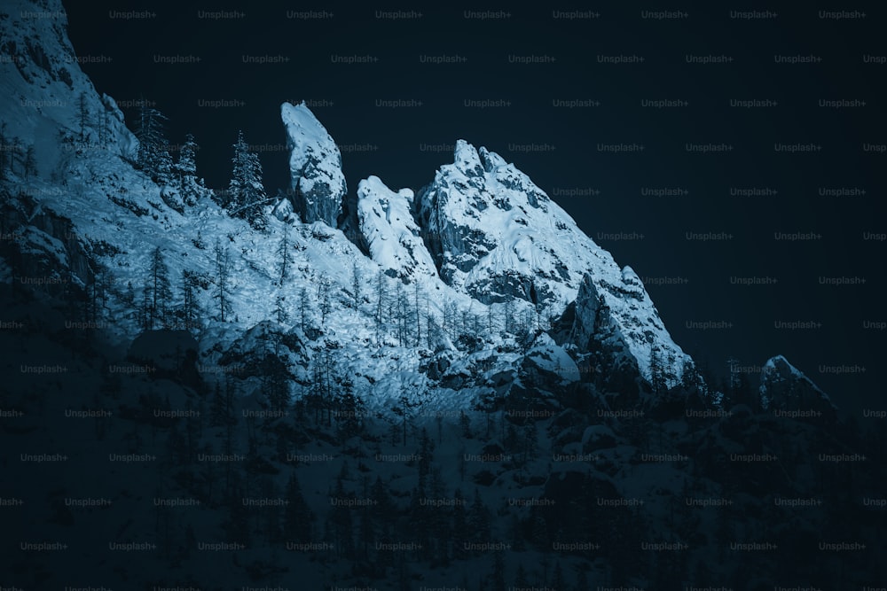 a mountain covered in snow at night