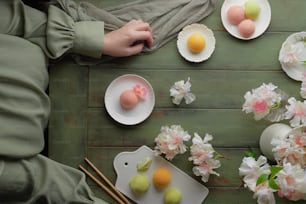 a person holding a plate of food on top of a table