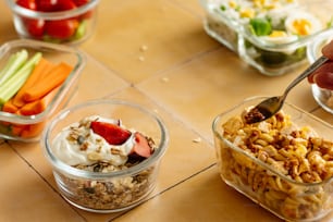 a table topped with bowls of food and a spoon