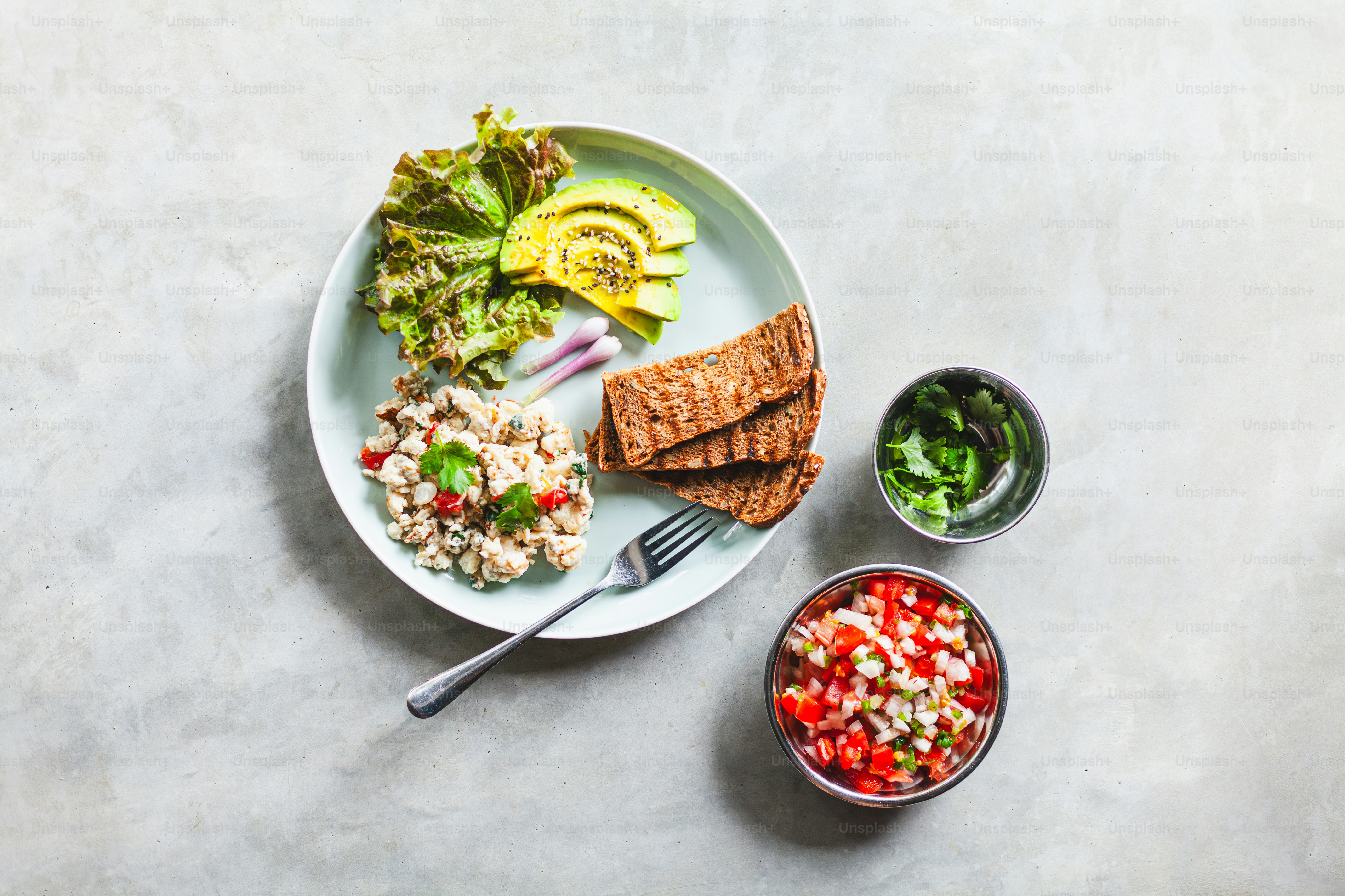 a white plate topped with salad and crackers