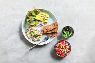 a white plate topped with salad and crackers