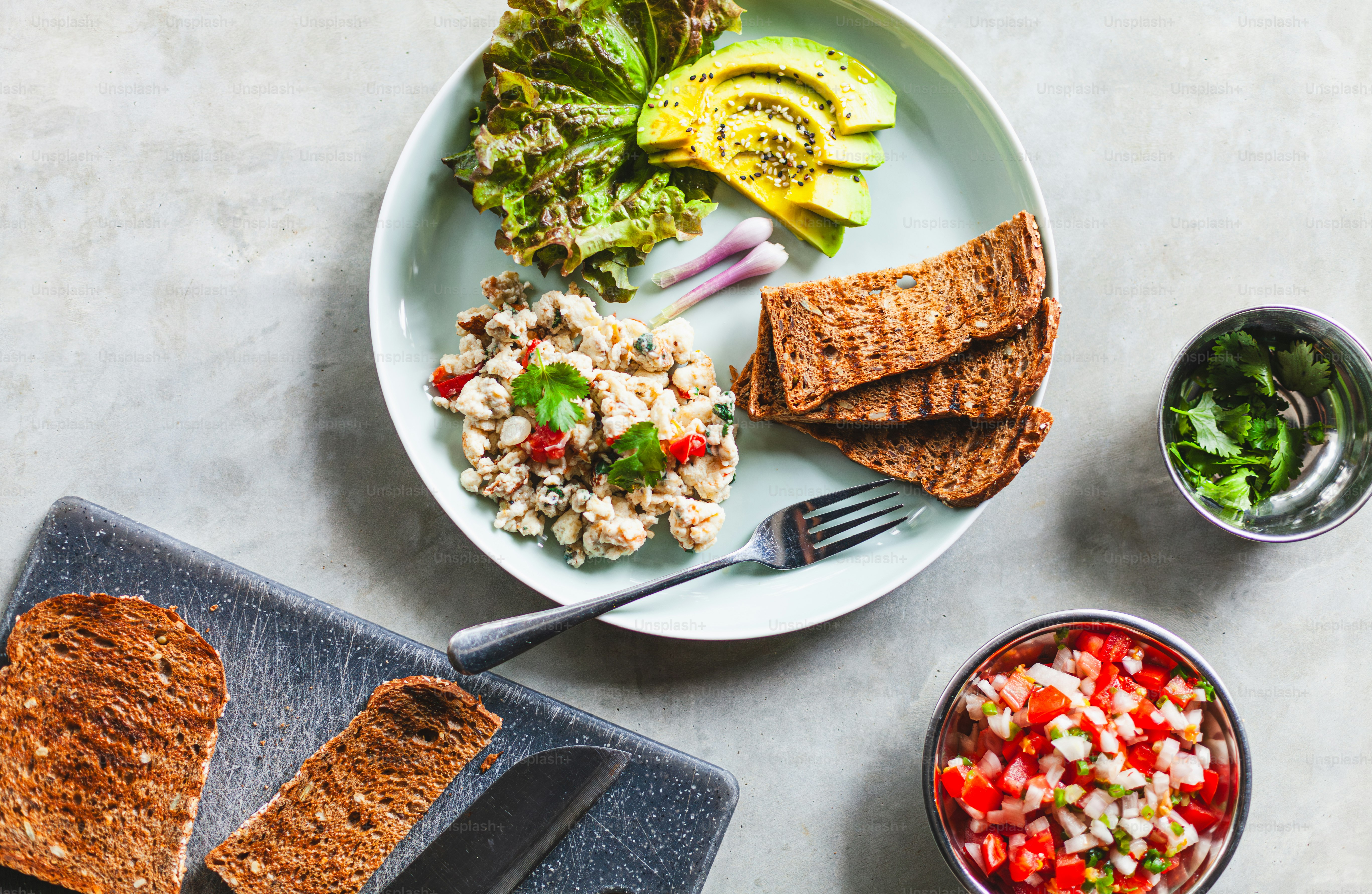 A plate of food with bread, salad, and avocado photo – Food Image on ...