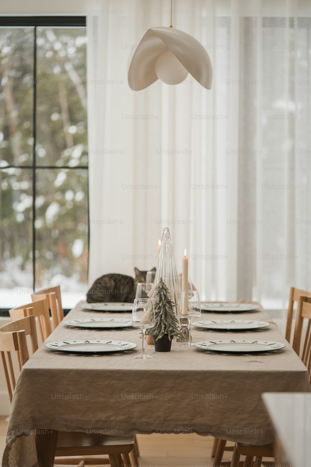 a dining room table with a cat sleeping on the table