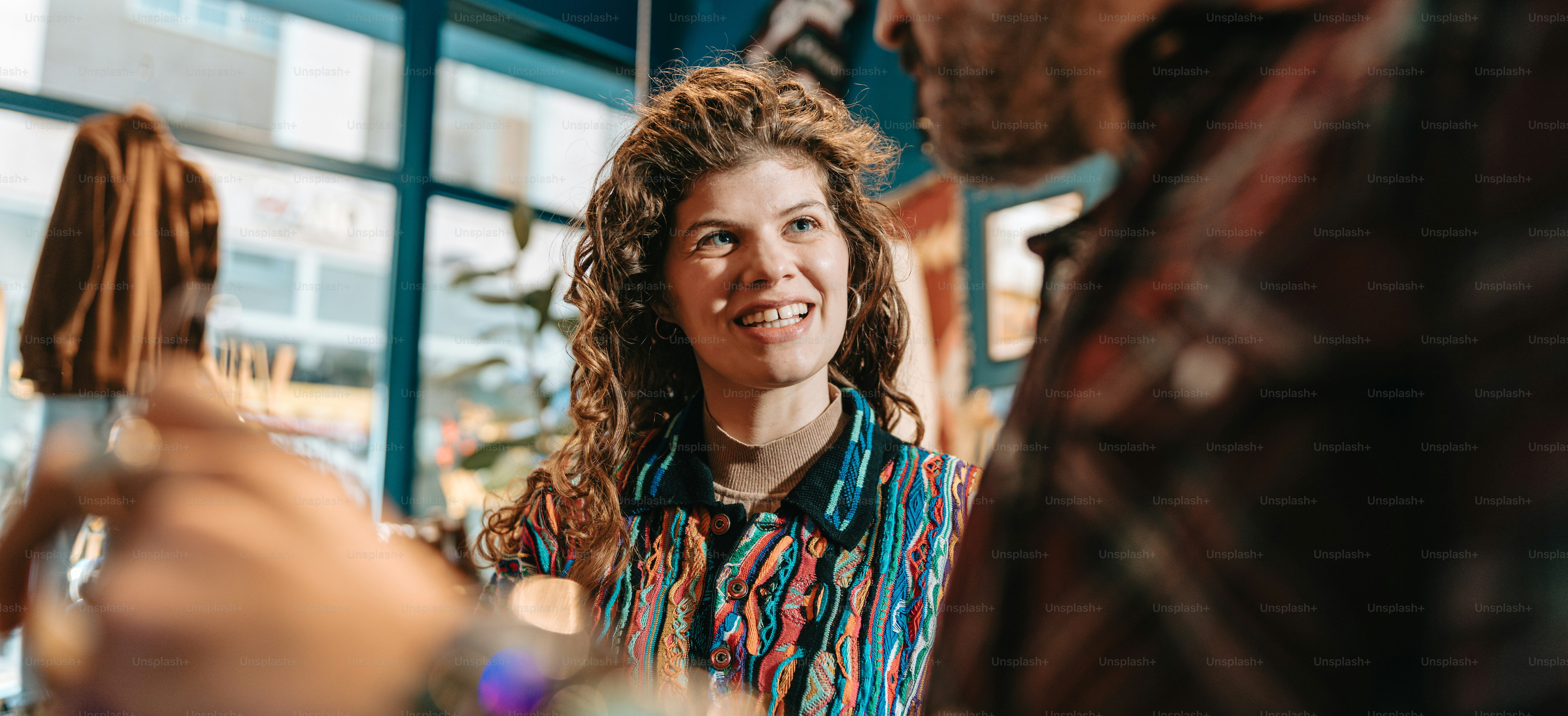 a woman smiles as she talks to a man