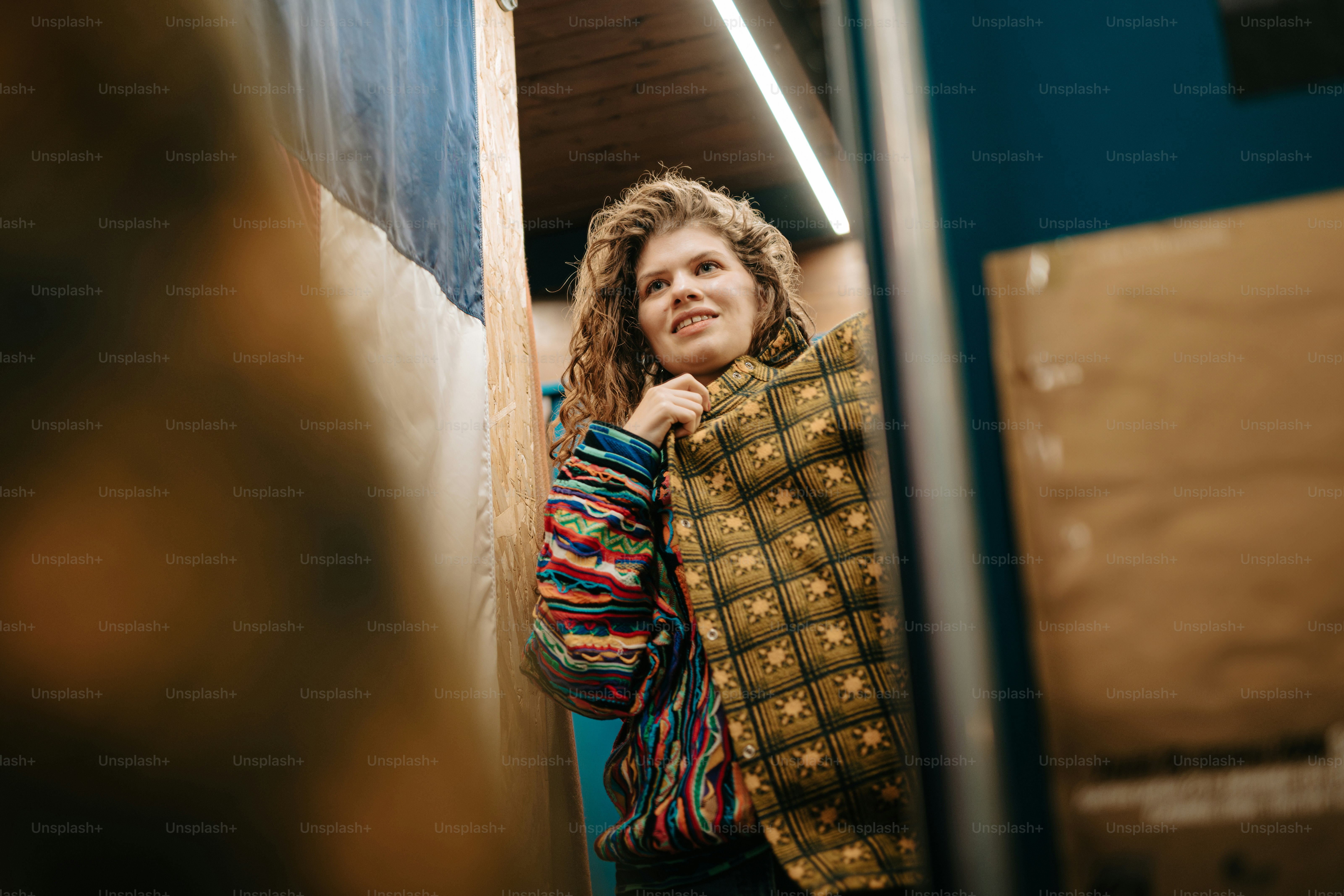 a woman standing in front of a mirror in a room