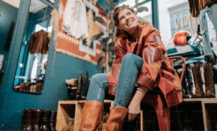 a woman sitting on top of a wooden crate