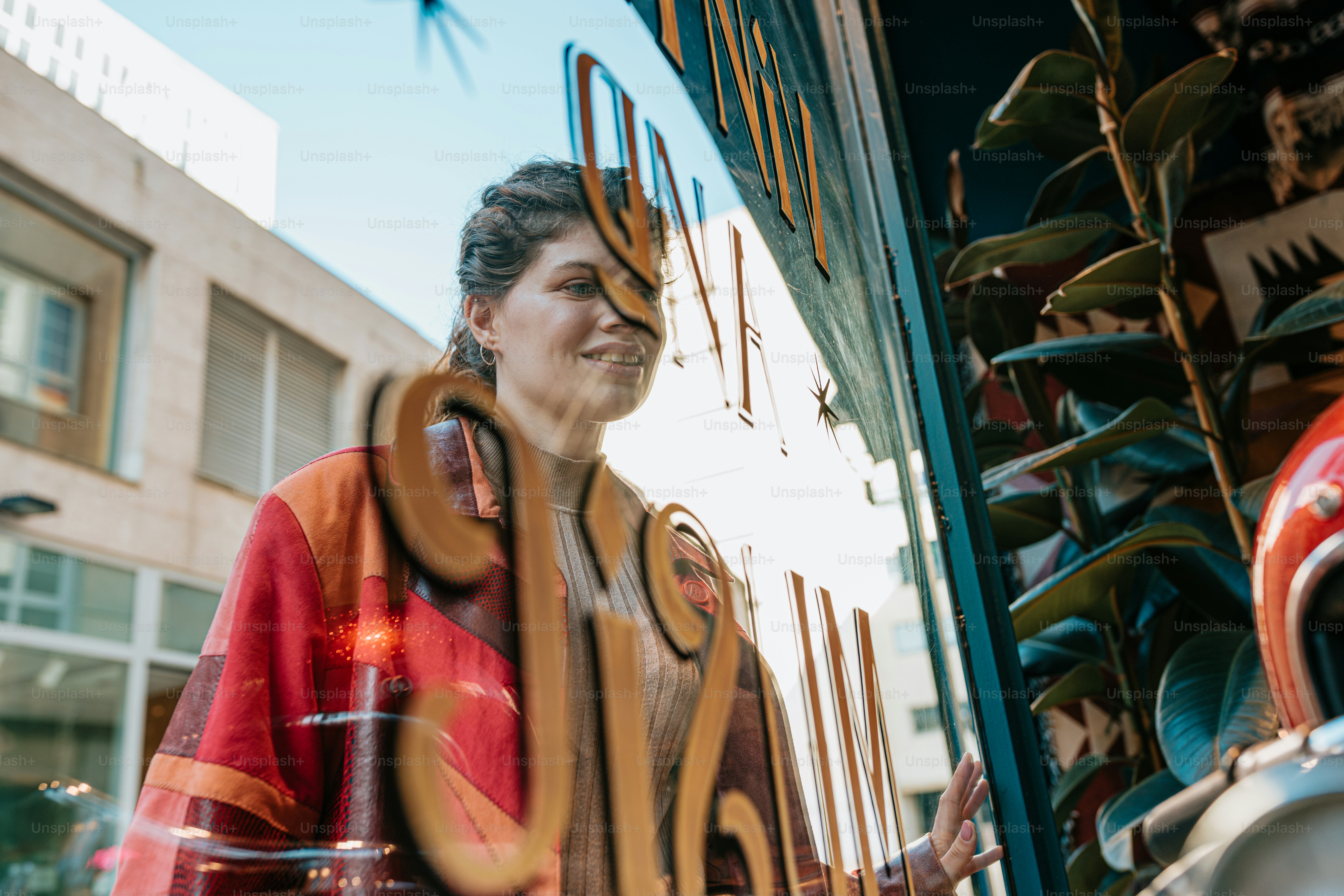 a woman standing in front of a store window