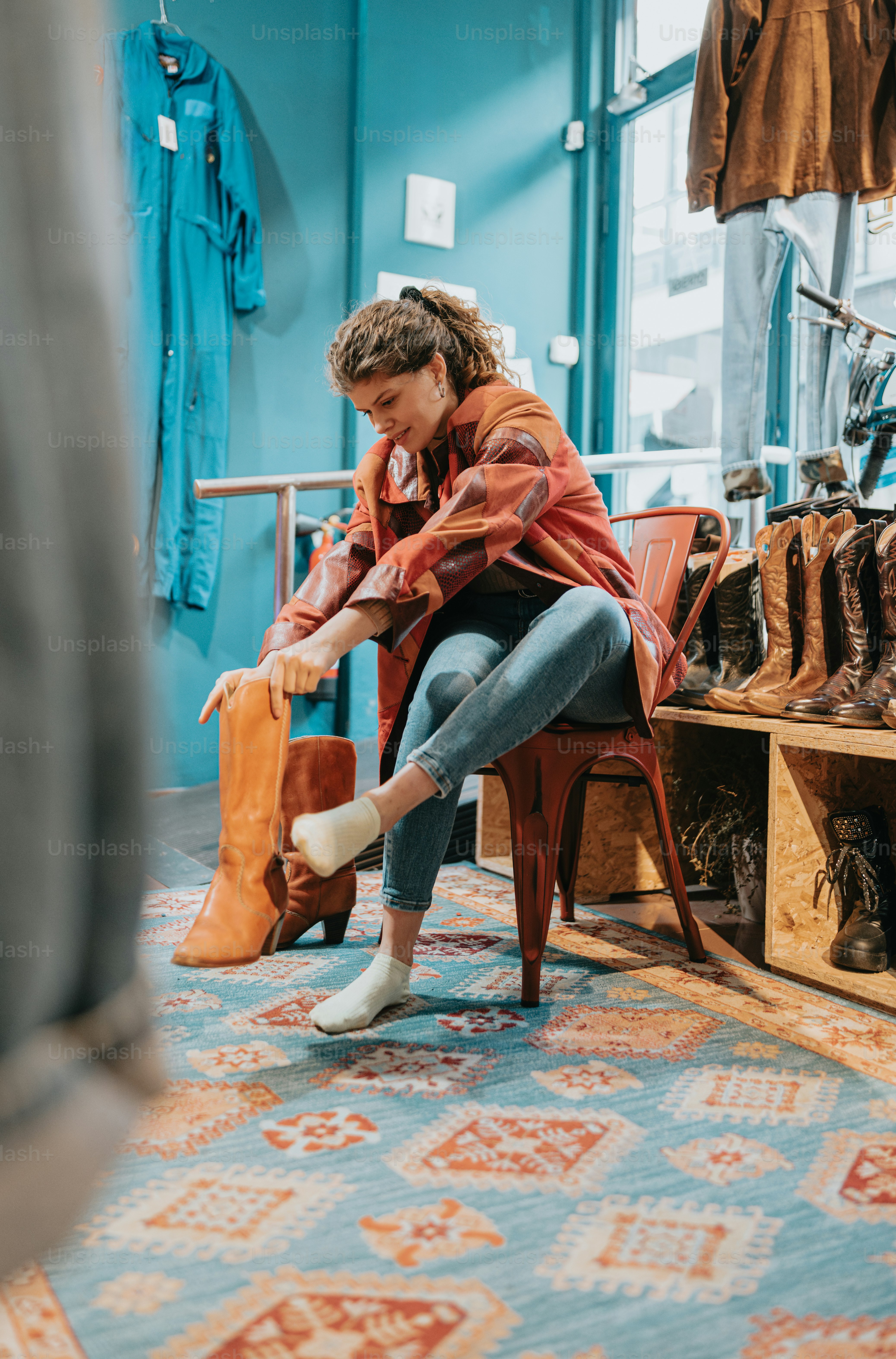 a woman sitting on a chair in a shoe store